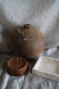 The round mud vase in large paired with our classic marble tray and wooden incense holder